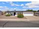 Charming single-story home with well-kept landscaping, a tidy white exterior, and a spacious two-car garage at 635 N 67Th Pl, Mesa, AZ 85205