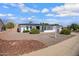 Charming one-story home with an easy-to-maintain gravel yard, complemented by vibrant flowering bushes at 635 N 67Th Pl, Mesa, AZ 85205