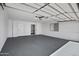Spacious garage with storage cabinets and painted floor at 635 N 67Th Pl, Mesa, AZ 85205