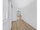 Hallway with new flooring leading to great room with natural light from large window at 635 N 67Th Pl, Mesa, AZ 85205