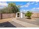 A convenient storage shed with a walkway in a well-maintained backyard at 635 N 67Th Pl, Mesa, AZ 85205