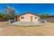 Exterior view of home showcasing a large concrete patio and neutral paint at 649 S Temple St, Mesa, AZ 85204