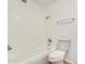 Bright bathroom featuring a tiled tub and shower combination and a white toilet at 649 S Temple St, Mesa, AZ 85204