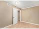 A bedroom with tile floors, neutral walls, white trim, and a closet with an open door at 649 S Temple St, Mesa, AZ 85204