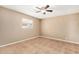A cozy bedroom offers natural light through a window and neutral walls with tile flooring at 649 S Temple St, Mesa, AZ 85204