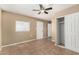 A bright bedroom featuring a ceiling fan, tile floors, and a closet for ample storage at 649 S Temple St, Mesa, AZ 85204