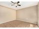An open bedroom with a ceiling fan and neutral-toned walls at 649 S Temple St, Mesa, AZ 85204