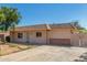 Single story tan colored home with a driveway leading up to the house and small front yard at 649 S Temple St, Mesa, AZ 85204