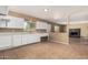 Neutral kitchen with white cabinets, a serving counter and a view into the living room at 649 S Temple St, Mesa, AZ 85204