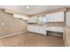 Kitchen with white cabinets, tile floor, neutral paint, and plenty of counter space at 649 S Temple St, Mesa, AZ 85204