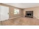 Living room with neutral paint, tile floors, rock fireplace and exterior door at 649 S Temple St, Mesa, AZ 85204