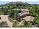 Stunning aerial view of the home with lush landscaping and mountain backdrop at 6624 N 66Th N Pl, Paradise Valley, AZ 85253