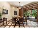 Formal dining room features stylish wood floors, decorative chandelier, and sliding doors to the outdoor patio at 6624 N 66Th N Pl, Paradise Valley, AZ 85253