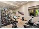 Home gym features mirrored wall, exercise equipment, and natural lighting at 6624 N 66Th N Pl, Paradise Valley, AZ 85253