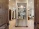 Elegant hallway featuring a built-in display case and neutral tile flooring at 6624 N 66Th N Pl, Paradise Valley, AZ 85253