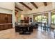 Spacious living room featuring high ceilings, wooden beams, and tile flooring at 6624 N 66Th N Pl, Paradise Valley, AZ 85253