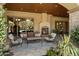 Relaxing outdoor patio with a fireplace, comfortable seating, and views of the lush landscaping and pool at 6624 N 66Th N Pl, Paradise Valley, AZ 85253