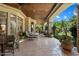 Covered outdoor patio featuring stone columns, and patio furniture at 6624 N 66Th N Pl, Paradise Valley, AZ 85253