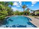 Beautiful swimming pool with a waterfall feature, lush landscaping, and ample space for outdoor seating and lounging at 6624 N 66Th N Pl, Paradise Valley, AZ 85253