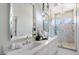 Bright bathroom with double sinks, modern fixtures, white cabinets, and a marble walk-in shower at 7222 E Gainey Ranch Rd # 241, Scottsdale, AZ 85258