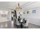 Bright dining room with a chandelier, wood floors, and seating for six at 7222 E Gainey Ranch Rd # 241, Scottsdale, AZ 85258