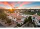 Beautiful townhouse with a red tile roof on a golf course, and a view of mountains at sunset at 7222 E Gainey Ranch Rd # 241, Scottsdale, AZ 85258