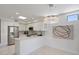 Well-lit kitchen with stainless steel appliances, white cabinets, and stylish chandelier at 7222 E Gainey Ranch Rd # 241, Scottsdale, AZ 85258