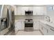 Modern kitchen featuring stainless steel appliances and white cabinets with stone countertops at 7222 E Gainey Ranch Rd # 241, Scottsdale, AZ 85258