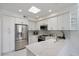 Modern kitchen features stainless steel appliances, white cabinets, and quartz countertops at 7222 E Gainey Ranch Rd # 241, Scottsdale, AZ 85258