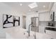 Modern kitchen with white cabinets, quartz countertops, and stainless steel appliances at 7222 E Gainey Ranch Rd # 241, Scottsdale, AZ 85258