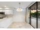 Kitchen with stainless steel appliances, white cabinetry, and a sliding door to a patio at 7222 E Gainey Ranch Rd # 241, Scottsdale, AZ 85258
