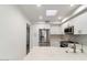 Well-lit kitchen with stainless steel appliances, white cabinetry, and a marble tile backsplash at 7222 E Gainey Ranch Rd # 241, Scottsdale, AZ 85258