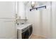 Convenient laundry room with full sized washer and dryer and built in shelving for storage at 7222 E Gainey Ranch Rd # 241, Scottsdale, AZ 85258
