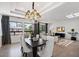 Bright living room with recessed lights, wood floors, black accents, and large windows at 7222 E Gainey Ranch Rd # 241, Scottsdale, AZ 85258