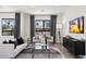 Bright living room featuring modern decor, a flat-screen TV, and comfortable seating at 7222 E Gainey Ranch Rd # 241, Scottsdale, AZ 85258