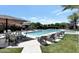 Resort-style community pool featuring lounge chairs, shaded tables, and manicured landscaping for relaxation and recreation at 7222 E Gainey Ranch Rd # 241, Scottsdale, AZ 85258