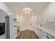 Bright kitchen features white cabinets, stainless steel appliances, and modern lighting at 7710 E Gainey Ranch Rd # 142, Scottsdale, AZ 85258