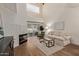 Bright living room features high ceilings, fireplace, modern furniture, and sliding glass doors at 7710 E Gainey Ranch Rd # 142, Scottsdale, AZ 85258