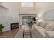 Inviting living room featuring a fireplace, modern furniture, and bright natural light at 7710 E Gainey Ranch Rd # 142, Scottsdale, AZ 85258