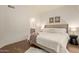 A bright main bedroom with ensuite bath featuring a comfortable bed with stylish lamps and contemporary decor at 7710 E Gainey Ranch Rd # 142, Scottsdale, AZ 85258