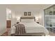 A cozy main bedroom bathed in natural light with a plush bed and ensuite bathroom at 7710 E Gainey Ranch Rd # 142, Scottsdale, AZ 85258