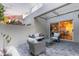 Cozy outdoor patio with stylish seating, beautiful pavers, and a sliding glass door at 7710 E Gainey Ranch Rd # 142, Scottsdale, AZ 85258
