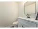 Modern powder room featuring a sleek vanity, elegant mirror, and contemporary fixtures at 7710 E Gainey Ranch Rd # 142, Scottsdale, AZ 85258
