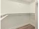 A well organized walk-in closet with shelving and rods for storage at 7710 E Gainey Ranch Rd # 142, Scottsdale, AZ 85258
