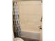 Bathroom with a tub-shower combo featuring a colorful shower curtain and tiled walls at 7807 E Main St # G-23, Mesa, AZ 85207