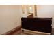 Cozy bedroom with view to bathroom featuring dark furniture and modern flooring at 7807 E Main St # G-23, Mesa, AZ 85207