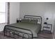 Cozy bedroom with a wrought iron bed frame and soft lighting at 7807 E Main St # G-23, Mesa, AZ 85207
