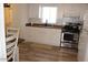 Cozy kitchen featuring a window, white cabinets, and stainless steel appliances at 7807 E Main St # G-23, Mesa, AZ 85207