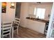Kitchen with modern white cabinets, stainless steel appliances, wood-look flooring, and an adjacent dining area at 7807 E Main St # G-23, Mesa, AZ 85207