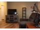 Relaxing living room features wood-look floors, a media center and a recliner for comfortable lounging at 7807 E Main St # G-23, Mesa, AZ 85207